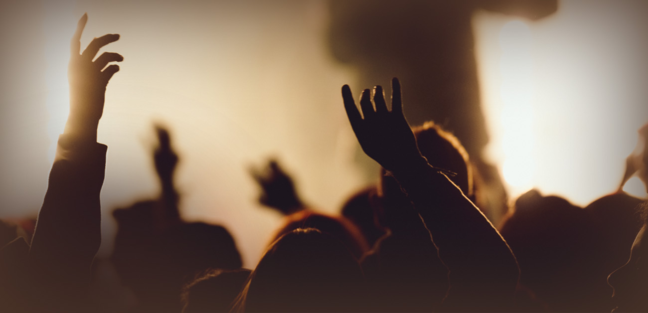 Congregation with hands raised in worship
